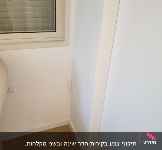 קיר צבוע בלבן ליד חלון עם תריסים